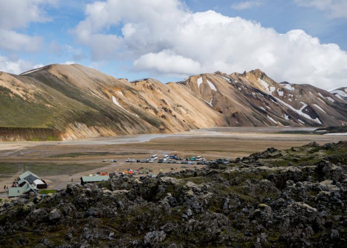 Standing on the lava field in Landmannalaugar looking over to the huts. The most characteristic mountain for landmannalaugar, Mt. Barmur in back.
