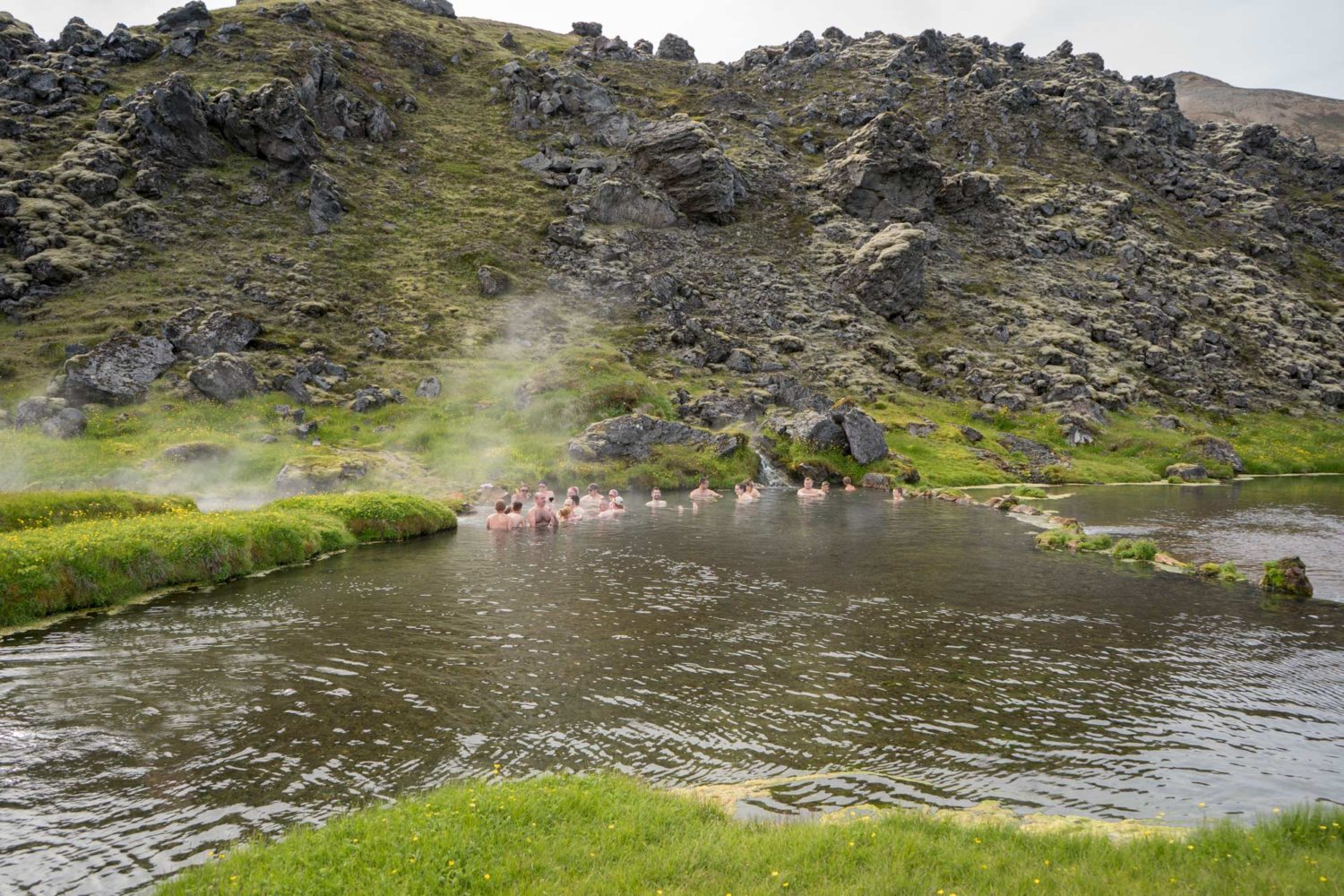 People bathing in the natural pool in Landmannalaugar