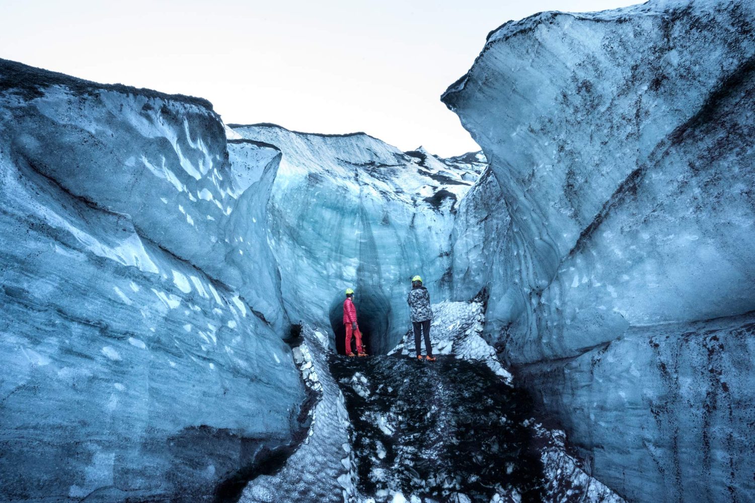 Mother and son standing outside of an ice cave