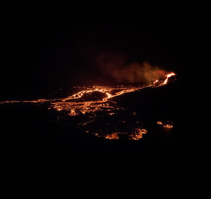 The volcanic eruption at night from distance.