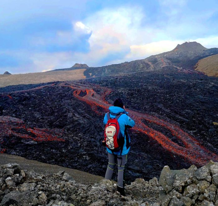 A customer photographs by the eruption site.