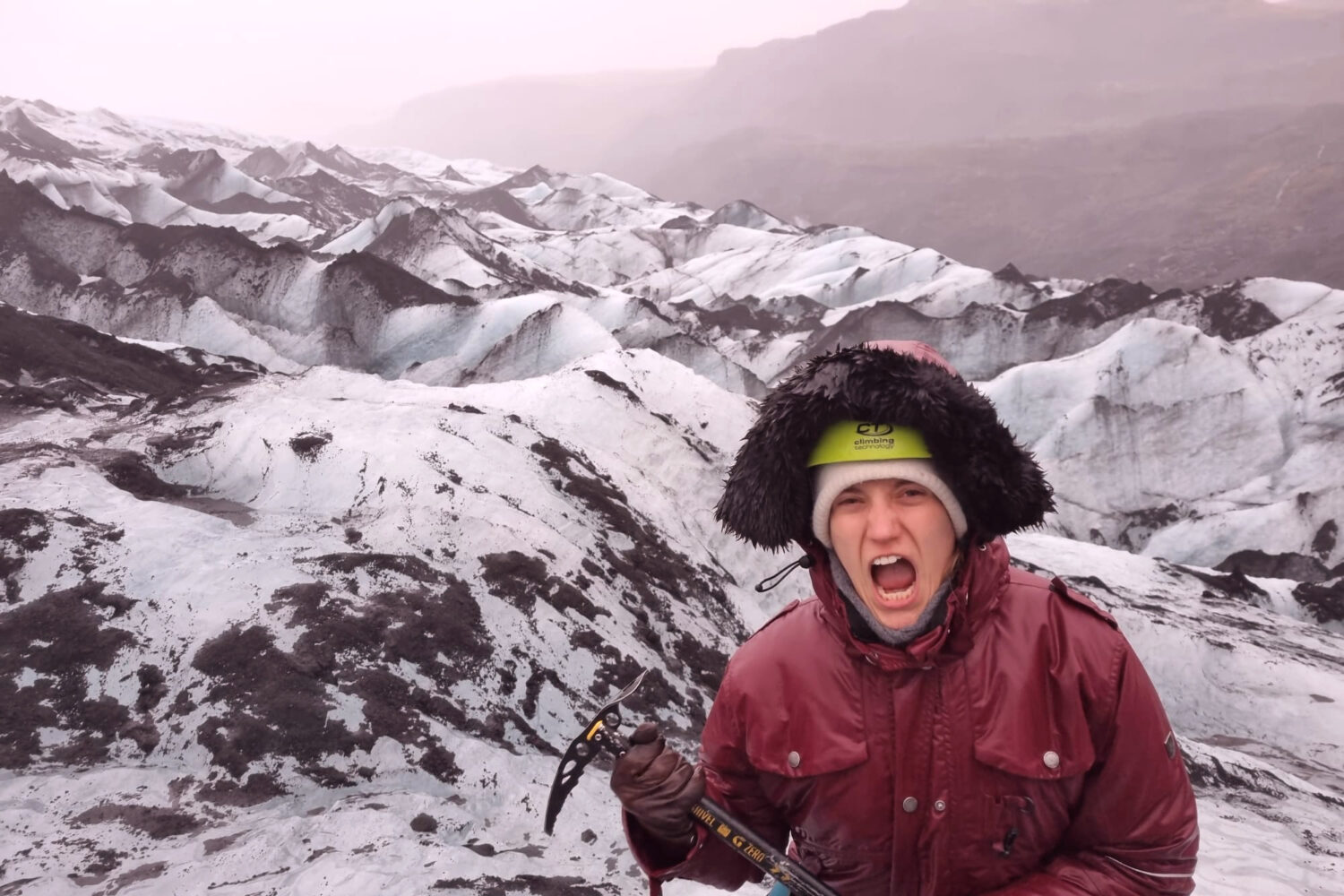 Woman screaming like a Viking on the glacier.
