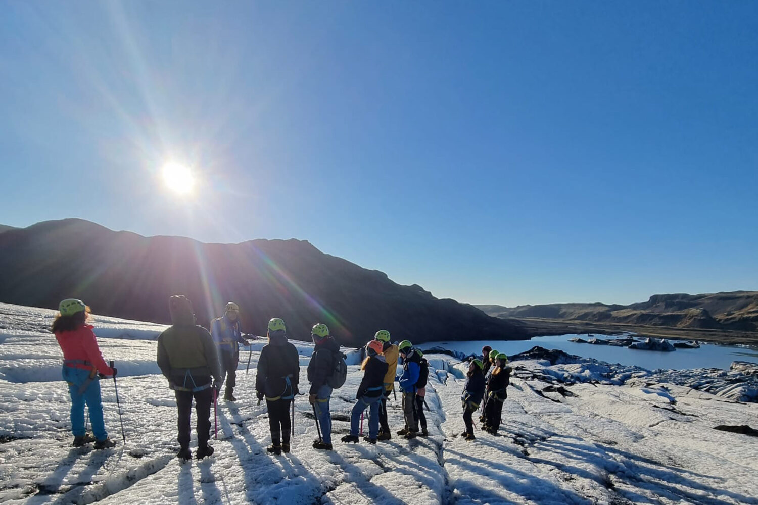 People standing on the glacier on a sunny day.