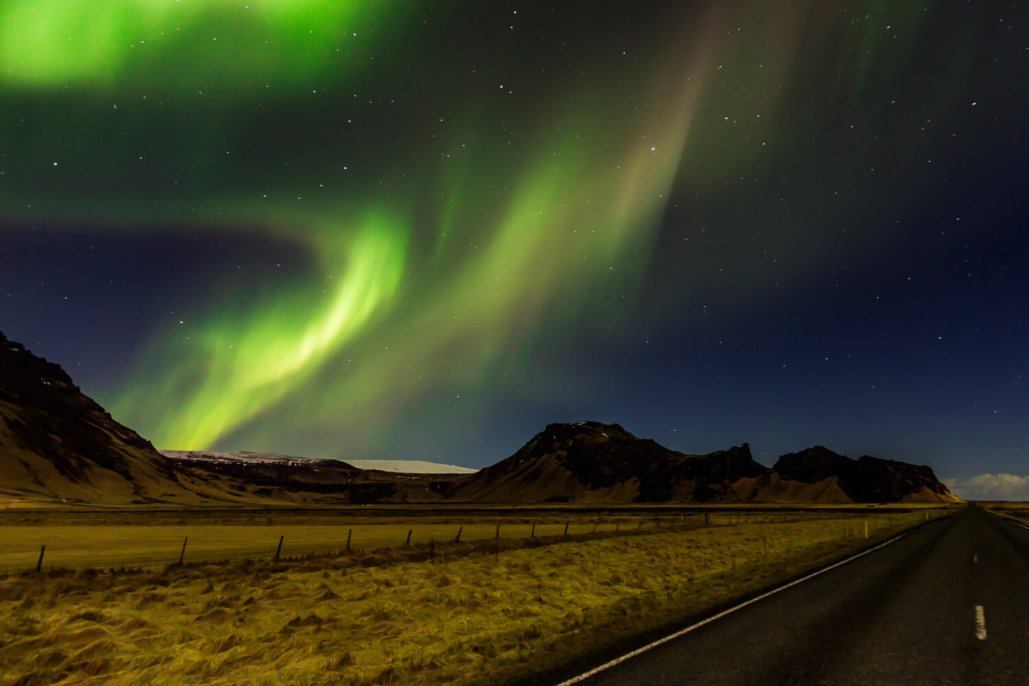 The Northern Lights dance across the Icelandic night sky.